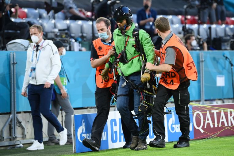 Police hold Greenpeace activist after parachute stunt in Allianz Arena