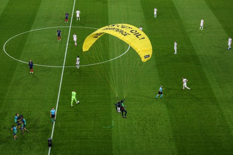 Police hold Greenpeace activist after parachute stunt in Allianz Arena