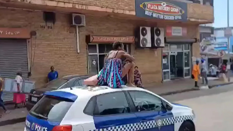 Woman Strips Naked on Metro Police Car in Durban